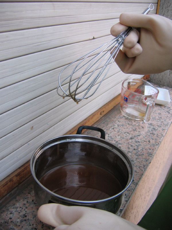 a person with a whisk attachment cooking soing in a pot
