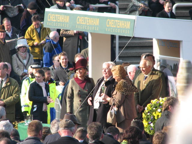 several elderly people at a sporting event while someone is handing out flowers