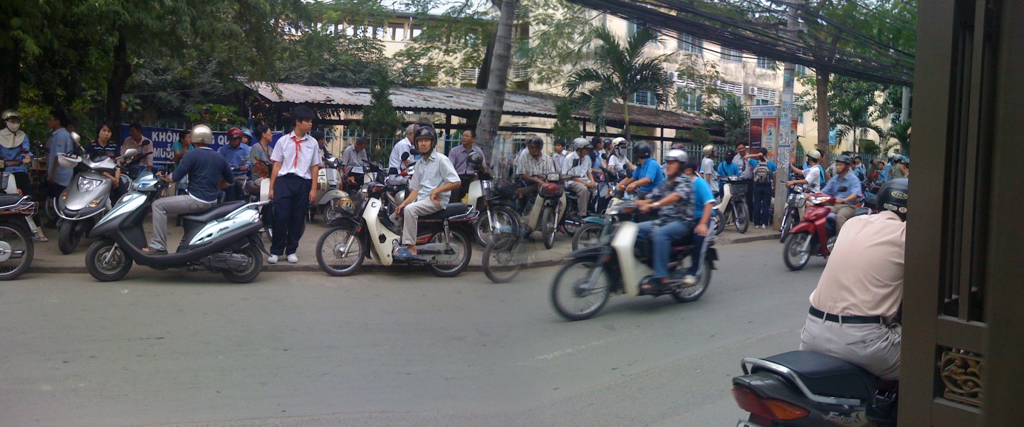 people are on motor bikes and scooters on the street