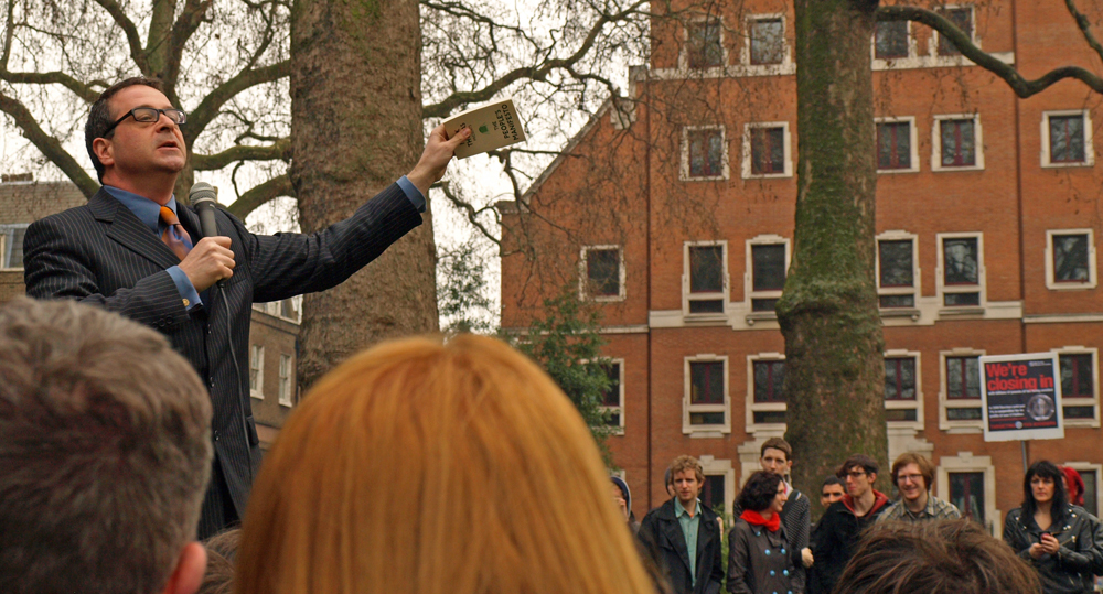 a man is holding soing near an audience