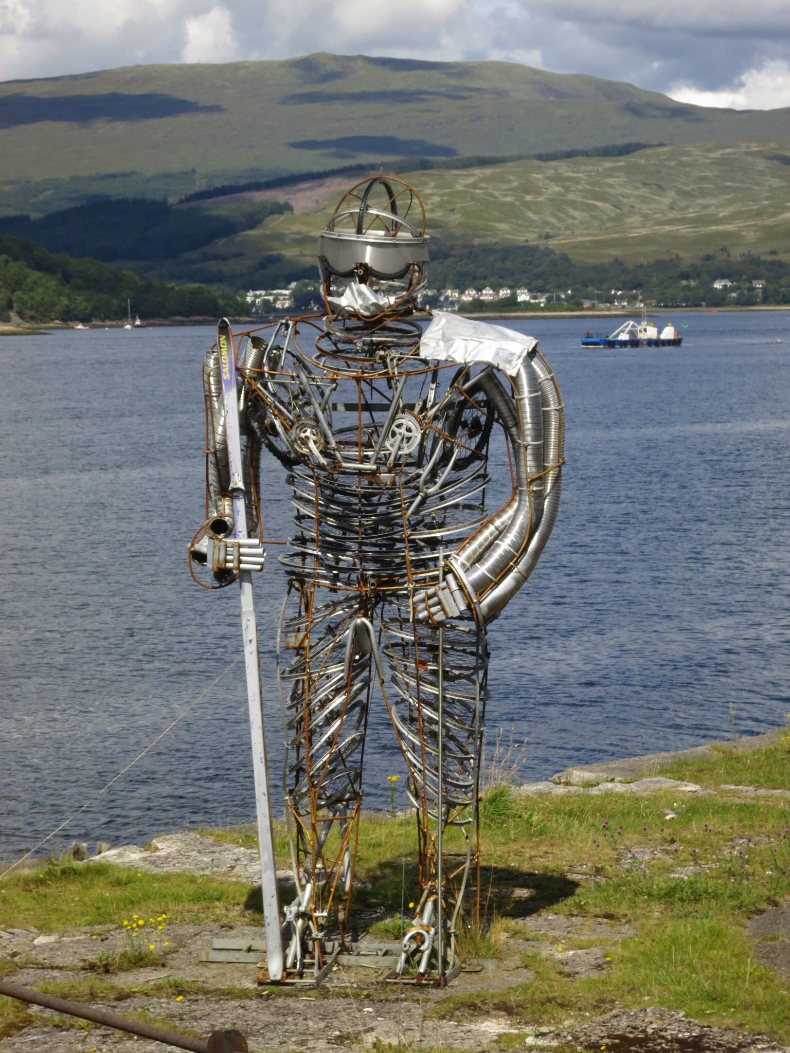 a sculpture on the side of a body of water