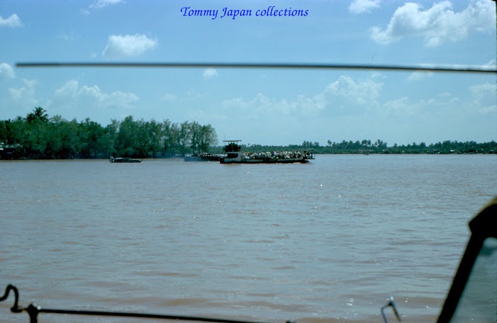 a boat sailing on a river near the shore