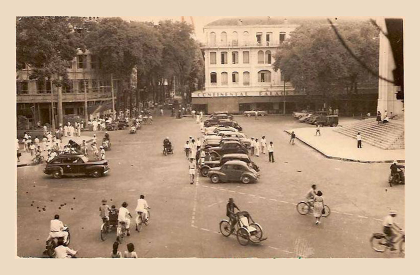 black and white pograph with many vehicles parked in lot