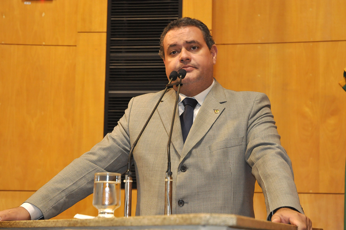 a man standing behind a podium giving a speech