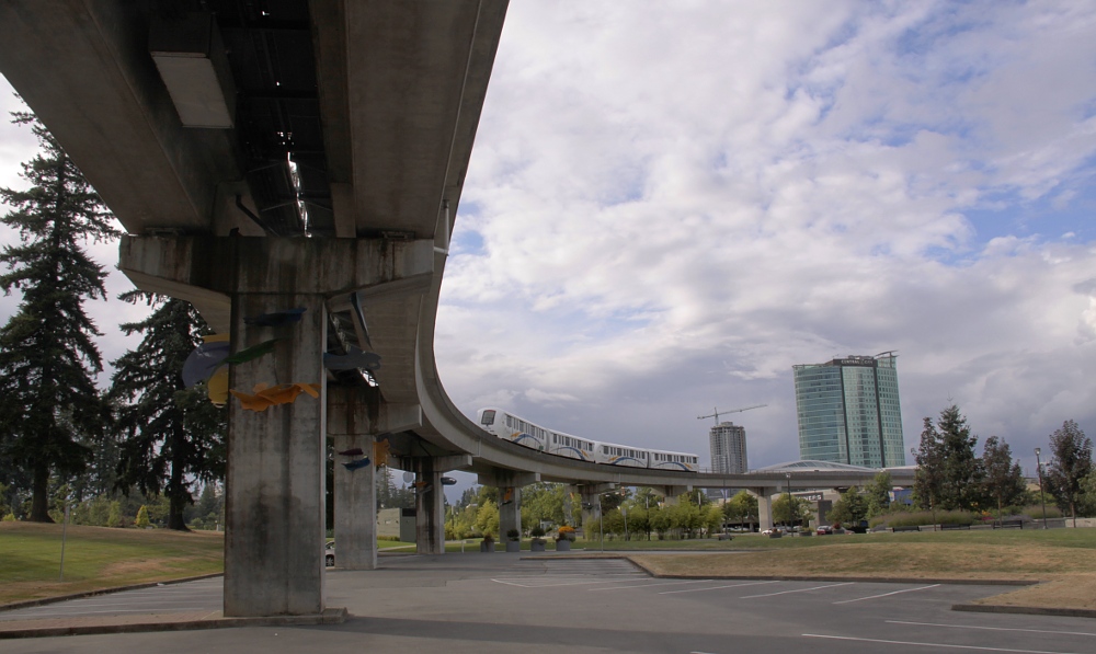 a city view with tall buildings under an overpass