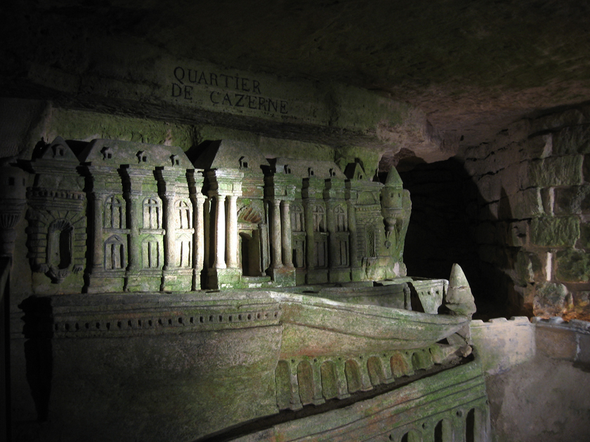 the interior of a cave, with green moss and light