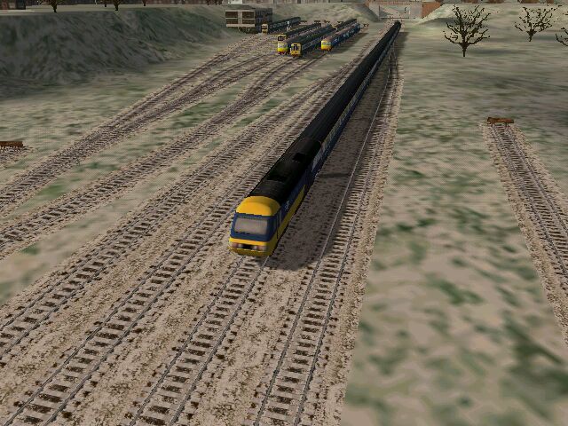 two trains in a field with a large amount of tracks