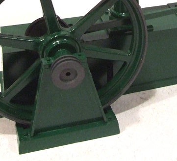 a close up of the side of an old green metal wheel