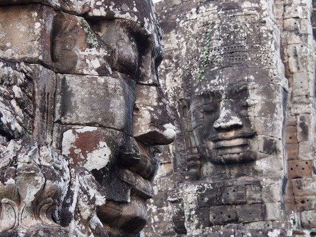 two faces in a large stone head building