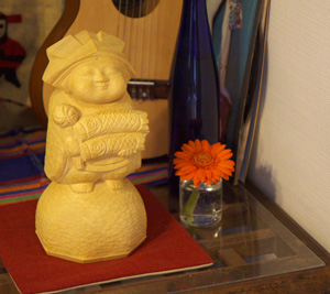 a vase sitting on a glass table next to a guitar