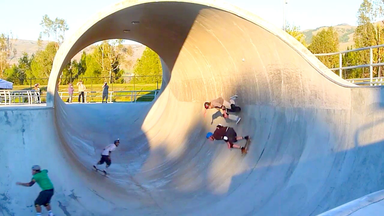 several skateboarders riding up and down a ramp in a half pipe area