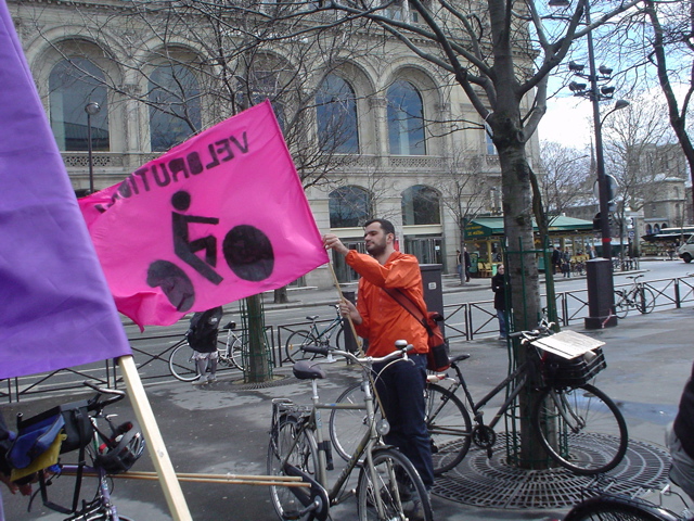 man with a bicycle and a purple sign