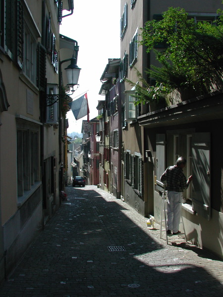 the old man is walking in between two narrow alleys