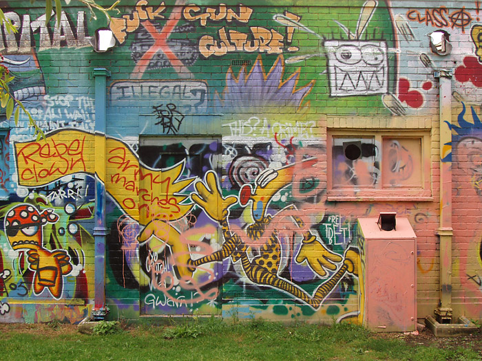 a building covered in graffiti, under construction