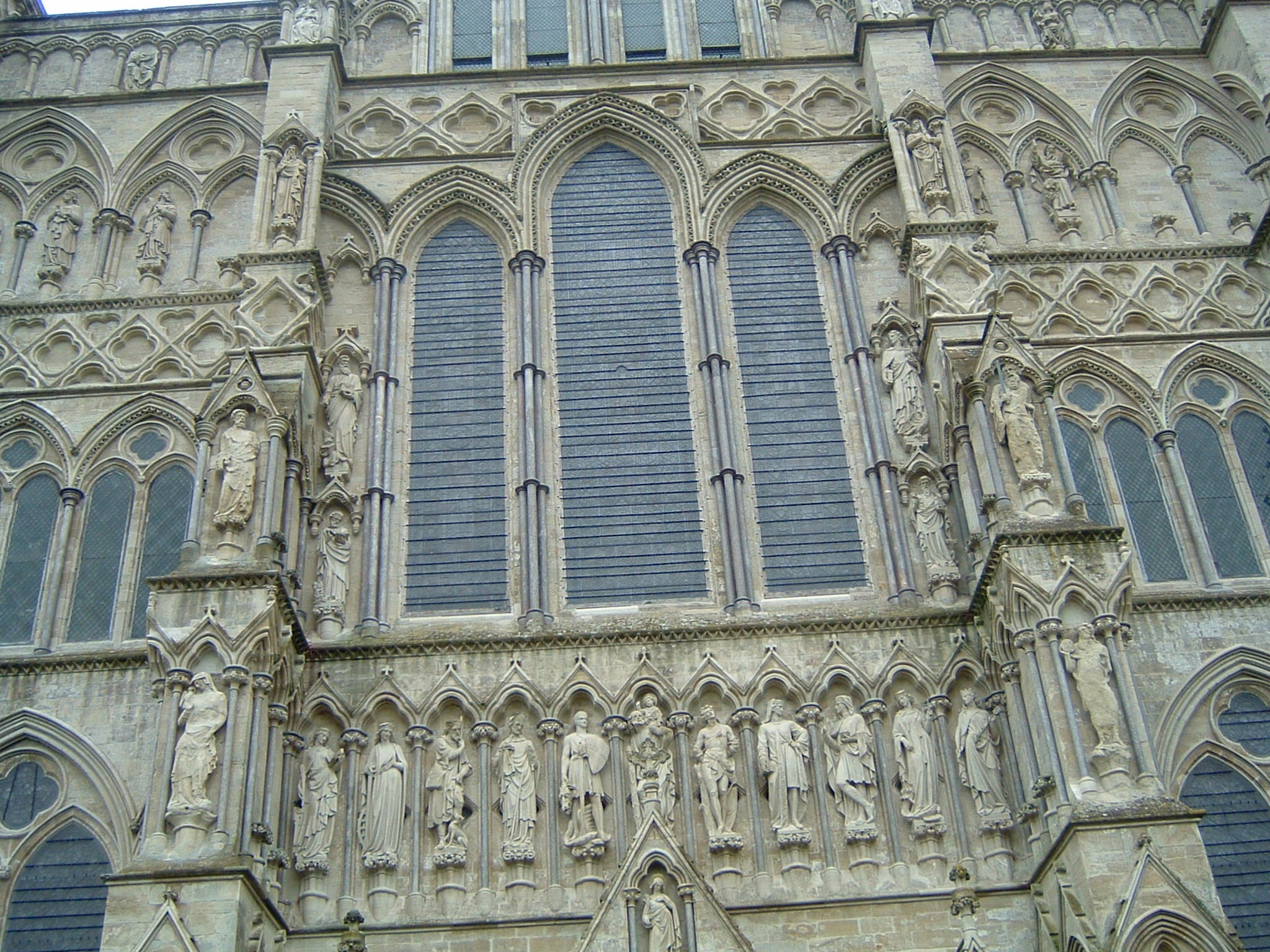 an architecturally intricate gothic building with two blue windows