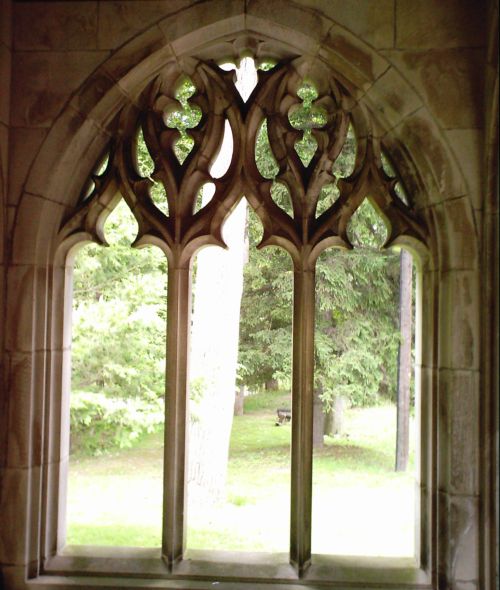 a window with two columns near trees