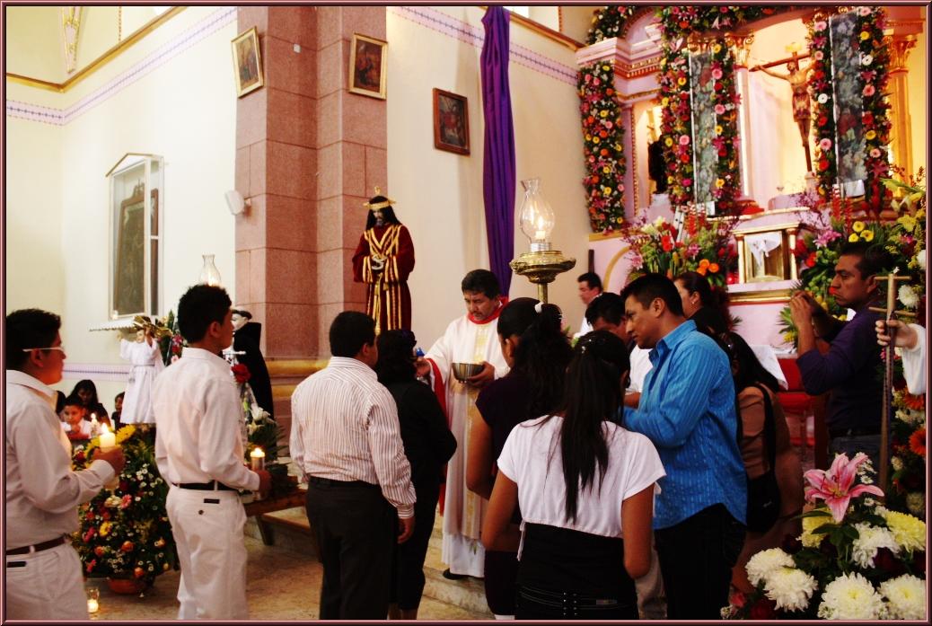 a group of people standing in front of a priest