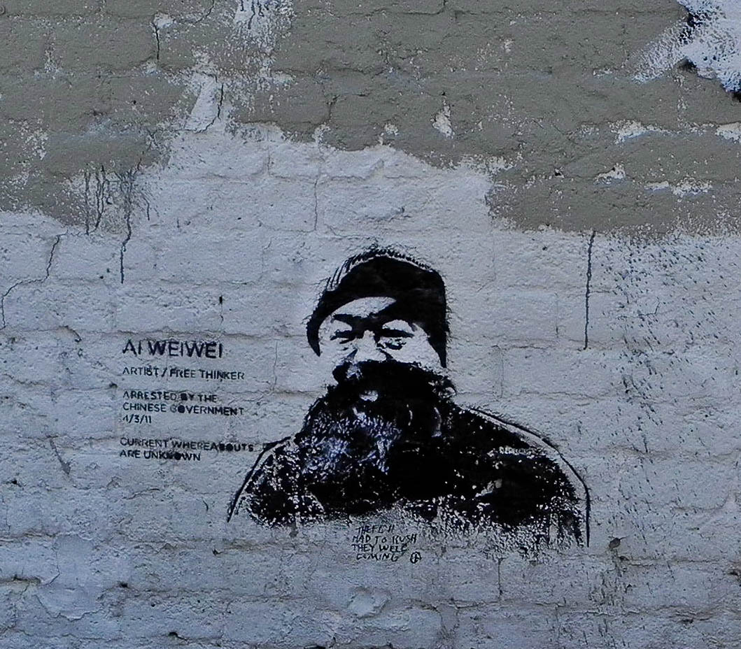 graffiti painted on the side of a wall of a man with a beard