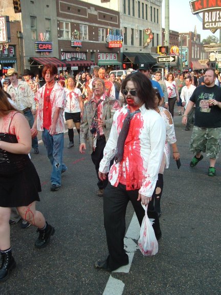 a group of zombie people walk down the street