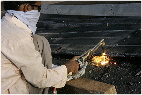 a welder working in an industrial metal shop