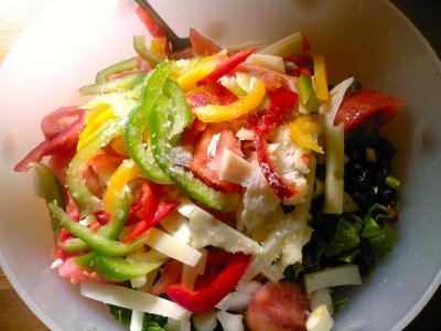 a white bowl filled with a salad on top of a wooden table