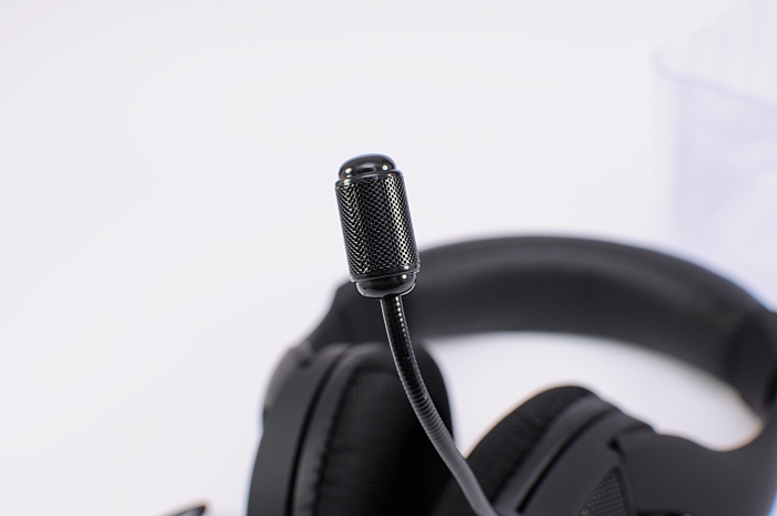 a black headphone is next to a microphone