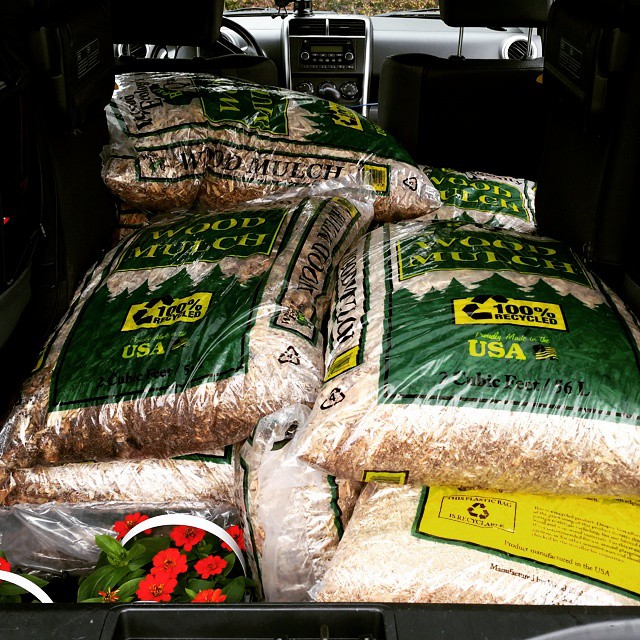 the inside view of a van loaded with green bags