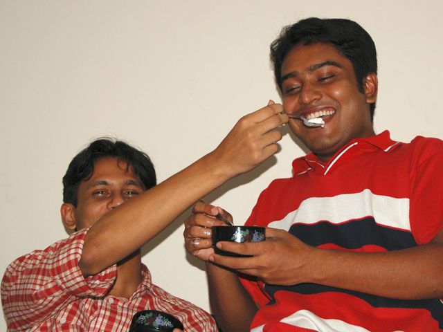 the two boys are brushing their teeth together