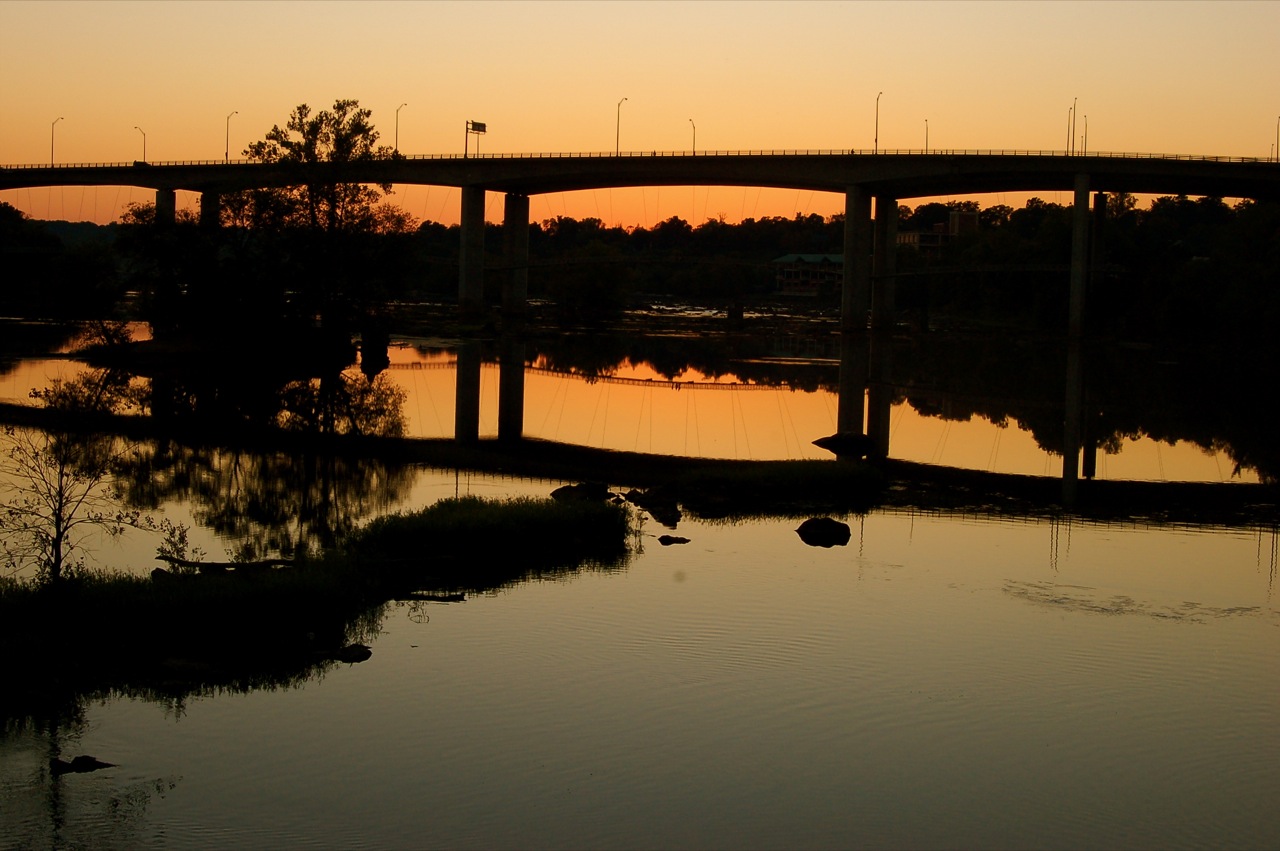 a large bridge with some traffic on the bridge over looking water