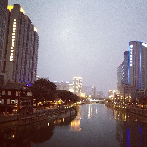 a waterway with buildings along it surrounded by water