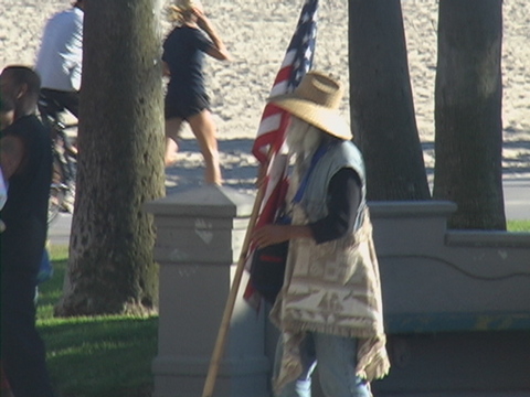man carrying a stick with american flag on it