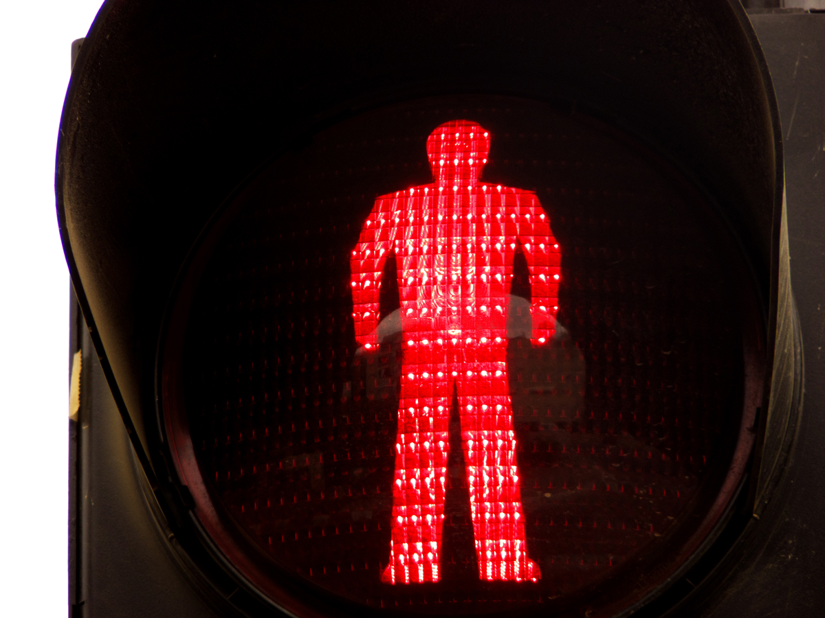 red pedestrian signal with image of man silhouette