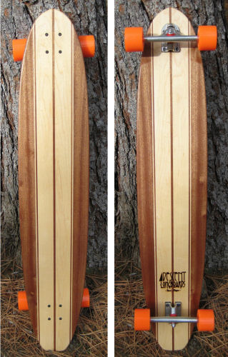 a pair of wooden skateboards on some dry grass
