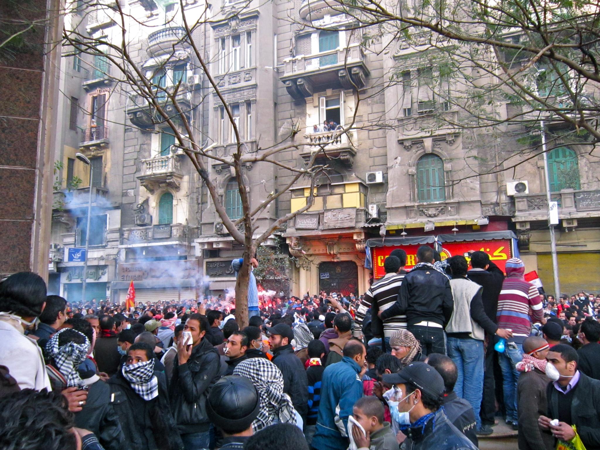 a group of people standing in front of tall buildings