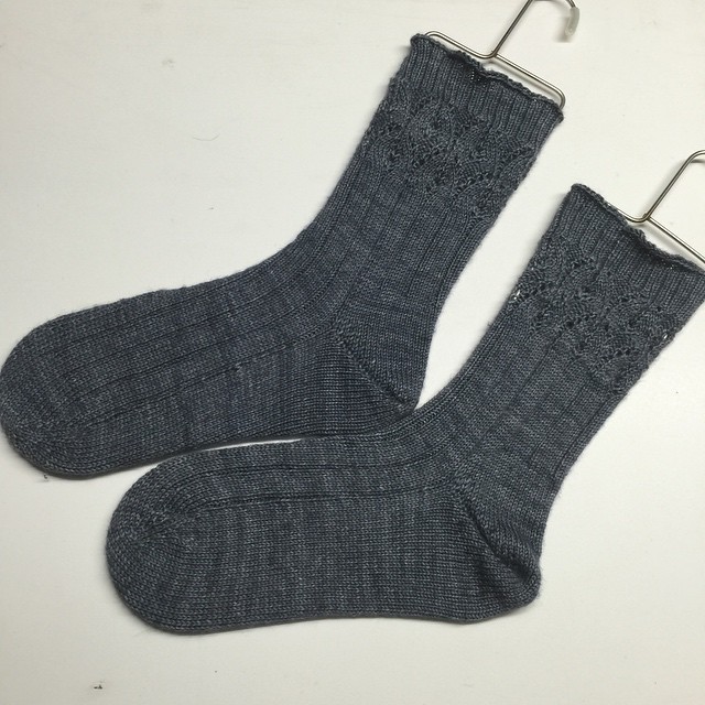 a pair of dark grey sock socks next to a clip