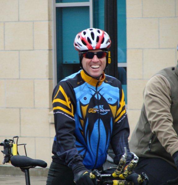 a man wearing helmet riding a bike next to a woman