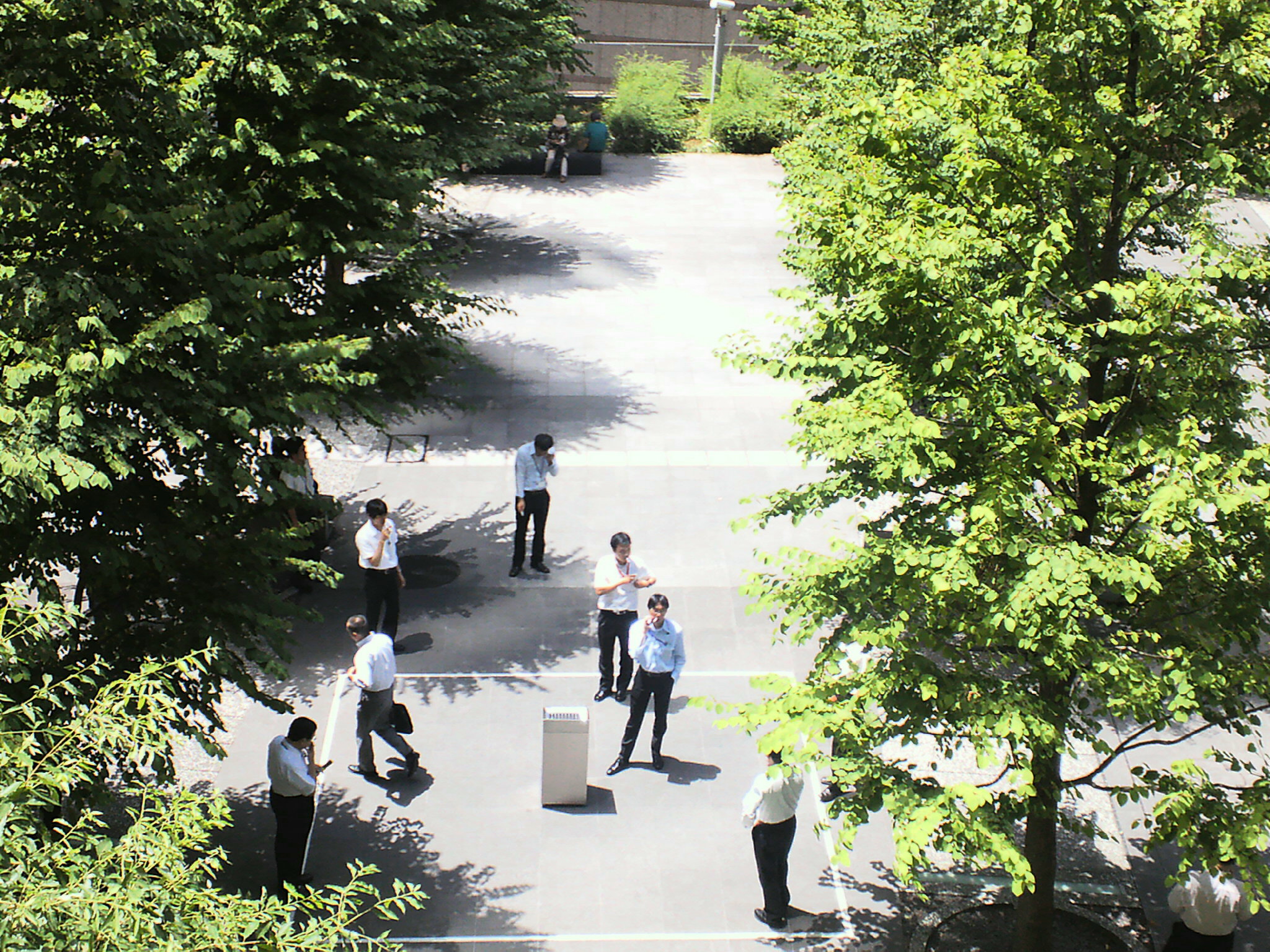 a group of people standing around each other in a courtyard