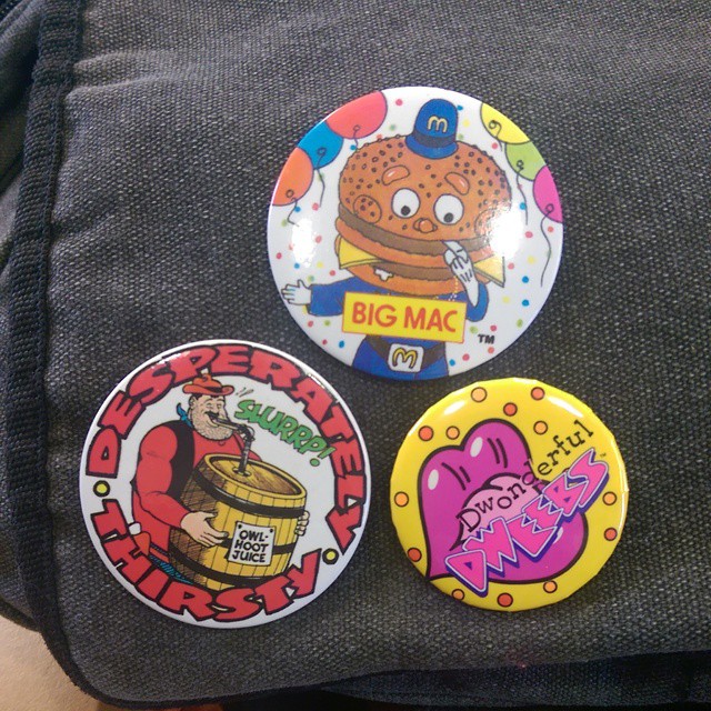 a few different badges on top of a piece of luggage