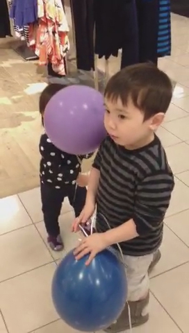 two s one is holding an enormous balloon