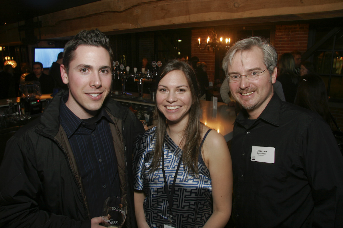 three people smile as they pose for the camera