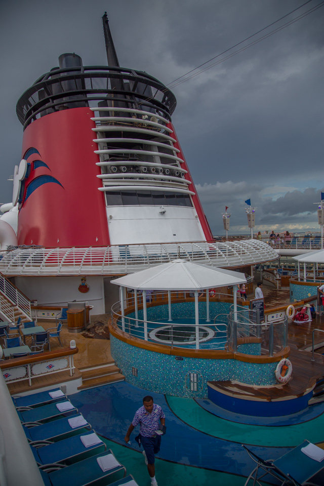 a man standing on the water near a cruise ship