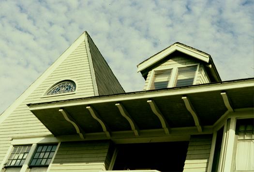 a home with a pitched roof and a clock on it