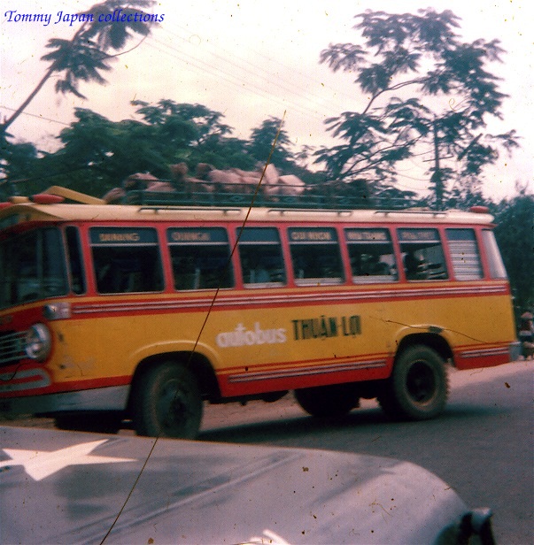 a red and yellow bus going down the road