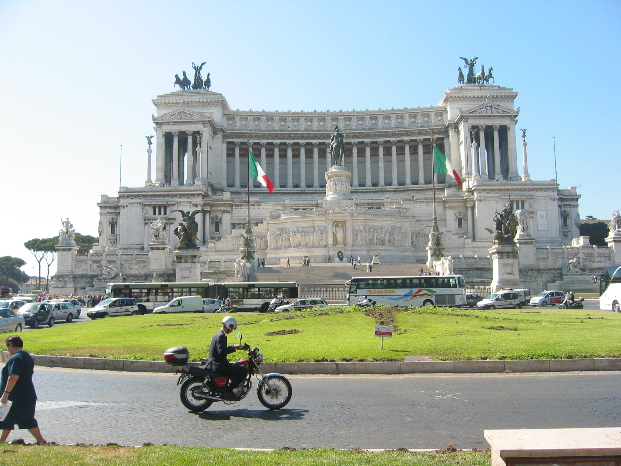 a man riding a motorcycle in front of a building
