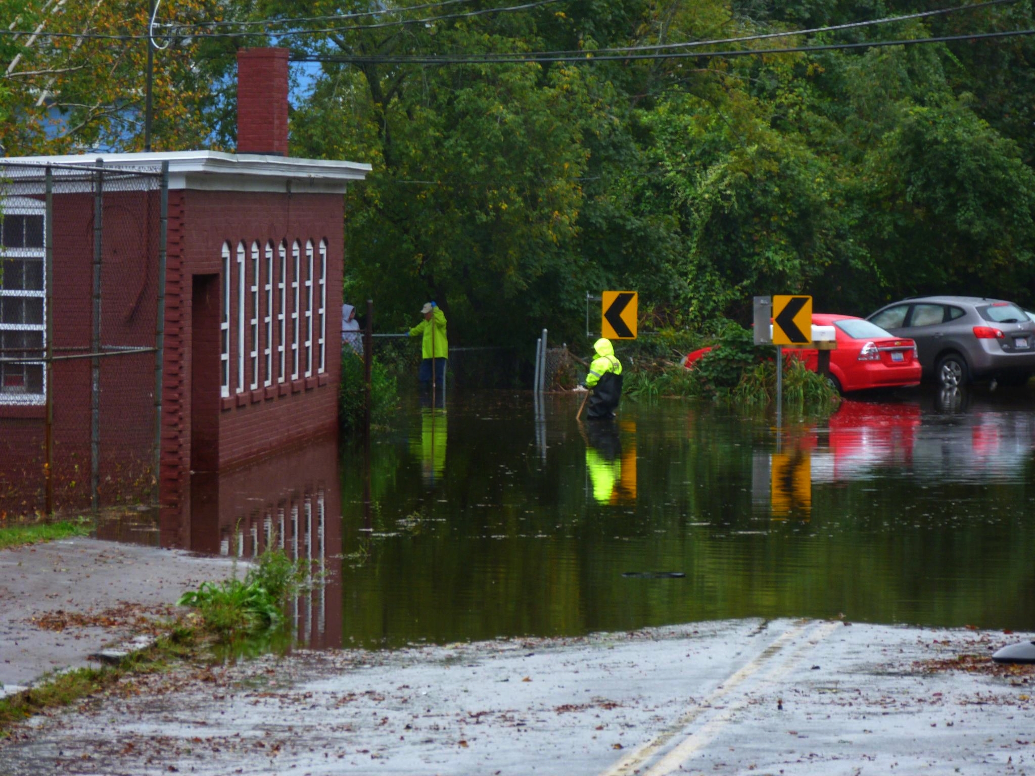 two people are working on their cars through water