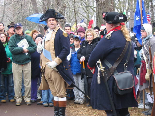 there is a man in a pirate costume talking to a woman