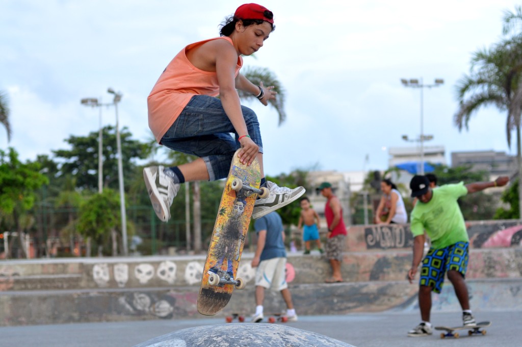 skate boarders riding skateboards at the park in the sunlight