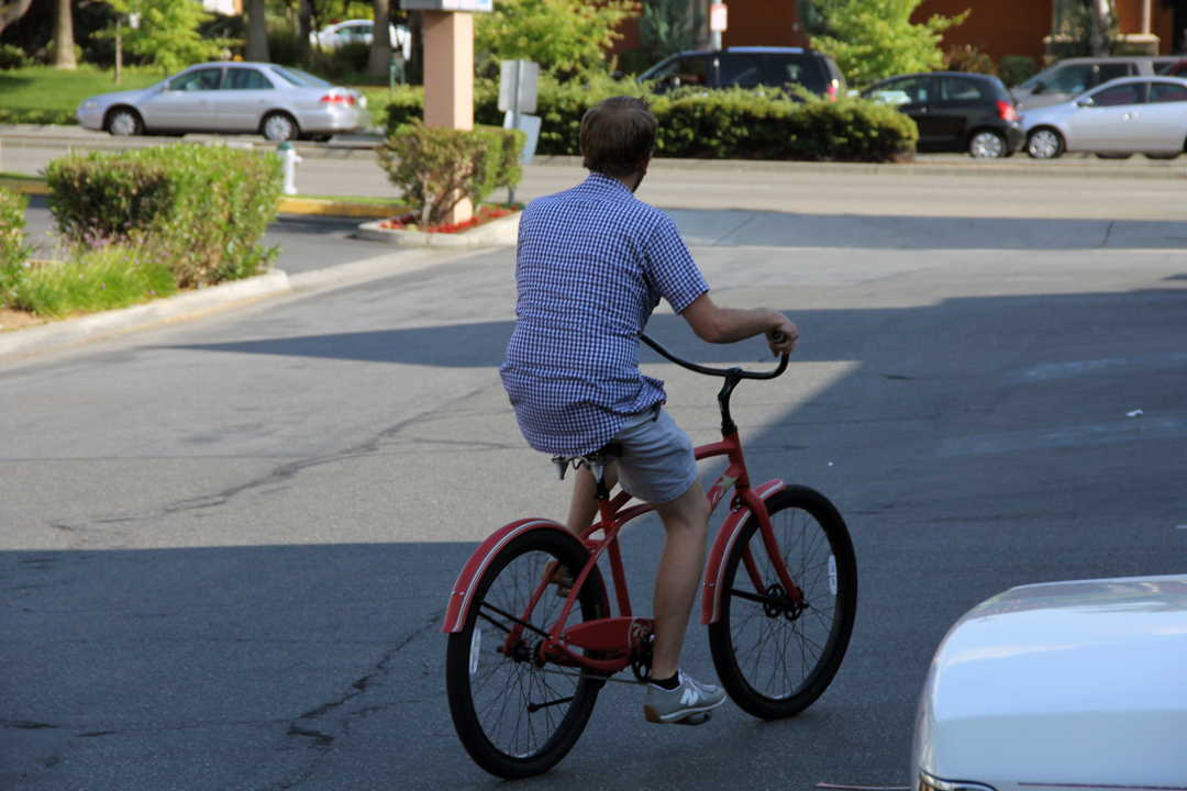 a man riding his bike across the street