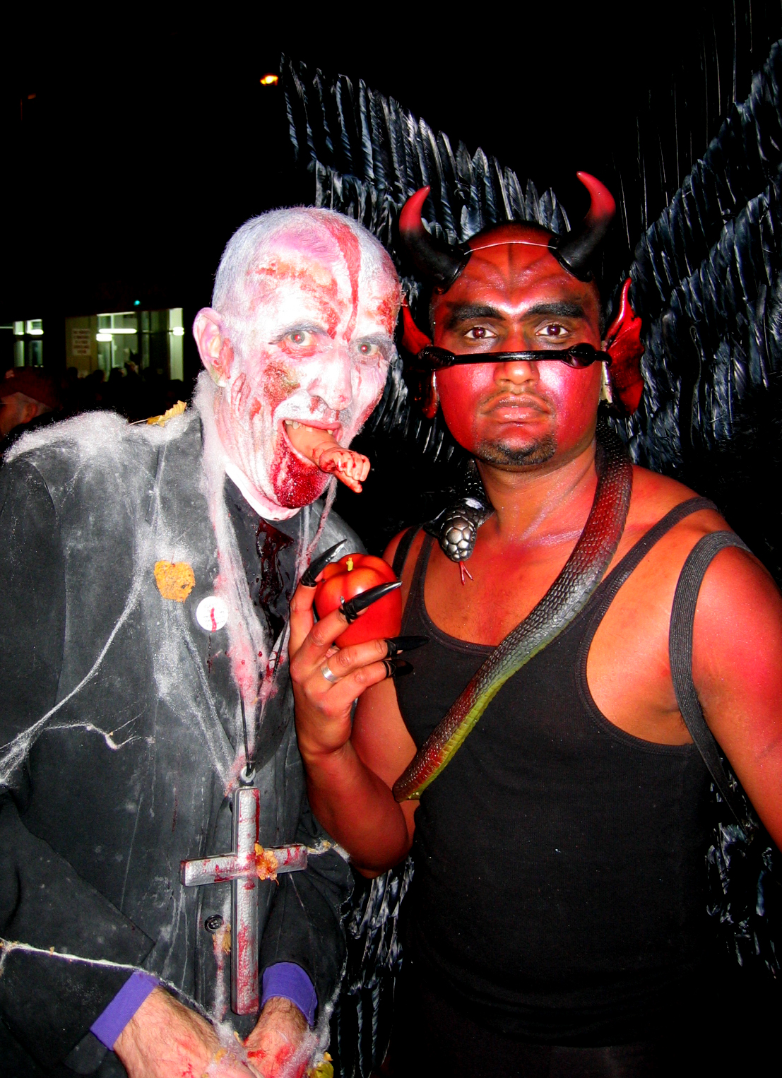 a couple of people with costume and devil horns