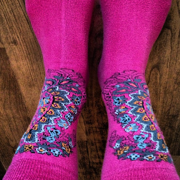 a pair of socks with paisley design sitting on top of a table